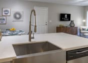 Thumbnail 3 of 52 - an open kitchen with a sink and a large counter top