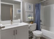 Thumbnail 11 of 52 - a white bathroom with a shower and a toilet and a sink
