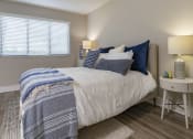 Thumbnail 10 of 52 - a bedroom with a bed with blue and white sheets and pillows