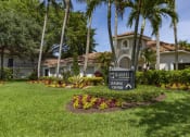Thumbnail 48 of 52 - a sign in front of a house with palm trees