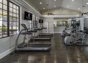 Thumbnail 17 of 52 - a gym with treadmills and other exercise equipment