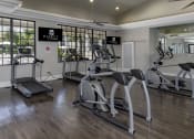 Thumbnail 19 of 52 - a gym with treadmills and other exercise equipment in a clubhouse