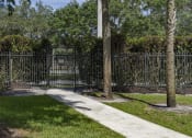 Thumbnail 33 of 52 - a sidewalk in front of a fence with a gate