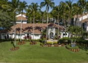 Thumbnail 51 of 52 - a mansion with a green lawn and palm trees