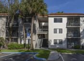Thumbnail 40 of 52 - a white apartment building with palm trees in front of it