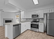 Thumbnail 13 of 43 - A kitchen with white cabinets and stainless steel appliances.