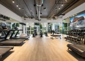 Thumbnail 41 of 66 - a gym with treadmills and other exercise equipment