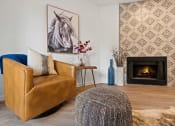 Thumbnail 2 of 28 - a living room with a leather chair and fireplace