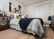 Thumbnail 9 of 28 - a bedroom with a bed and a dresser