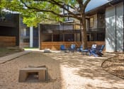 Thumbnail 23 of 28 - a fire pit and chairs in the courtyard of a building