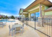 Thumbnail 33 of 52 - a patio with tables and chairs next to a swimming pool