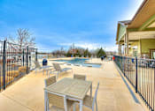 Thumbnail 40 of 52 - a patio with tables and chairs next to a pool