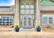 Thumbnail 1 of 52 - the front door of a house with two potted plants on the sidewalk