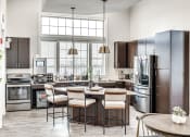 Thumbnail 20 of 52 - a kitchen with stainless steel appliances and a large window