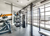 Thumbnail 47 of 52 - a home gym with a punching bag and weights