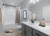 Thumbnail 22 of 39 - a bathroom with a shower and a sink and a toilet