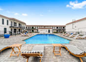 Thumbnail 7 of 22 - a swimming pool with lounge chairs around it