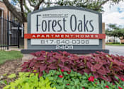 Thumbnail 24 of 24 - A sign for Westmont at Forest Oaks Apartment Homes with a phone number on it.