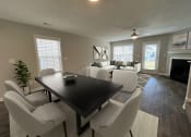 Thumbnail 2 of 36 - a living room and dining room with white chairs and a black table