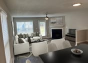 Thumbnail 3 of 36 - a living room with a couch and a table and a fireplace