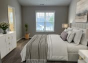 Thumbnail 6 of 36 - a bedroom with a large bed and a window