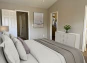 Thumbnail 5 of 36 - a bedroom with a bed and a dresser and a closet