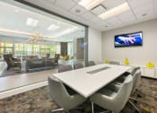 Thumbnail 27 of 44 - a conference room with a table and chairs and a television