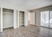 Thumbnail 9 of 18 - an empty living room with sliding glass doors to a closet