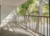 Thumbnail 11 of 18 - a balcony with a view of a yard and trees