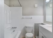 Thumbnail 10 of 18 - a bathroom with a toilet and a tub and a sink