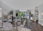 Thumbnail 2 of 18 - a living room with a dining room table and chairs and a balcony