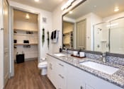 Thumbnail 4 of 30 - A bathroom with a toilet, sink, and mirror.