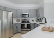 Thumbnail 1 of 39 - a kitchen with stainless steel appliances and marble counter tops