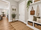 Thumbnail 11 of 33 - A hallway with a brown rug and a white door.