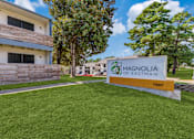 Thumbnail 1 of 20 - a sign with magnolia on eastman written on it in front of a building