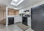 Thumbnail 13 of 20 - a kitchen with white cabinets and black appliances