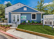 Thumbnail 20 of 20 - a blue house with a white sign in front of it