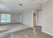 Thumbnail 11 of 20 - a bedroom with hardwood floors and grey walls