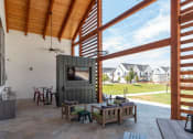 Thumbnail 20 of 30 - a living room with a tv and a patio