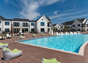Thumbnail 21 of 30 - a large swimming pool in front of an apartment building