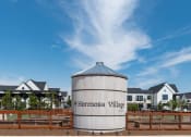 Thumbnail 17 of 30 - a grain silo sits in front of a row of houses