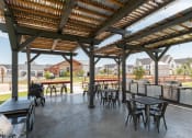Thumbnail 18 of 30 - a patio with tables and chairs and a pergola