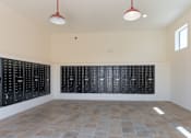 Thumbnail 38 of 38 - A room with black lockers on the wall and a tiled floor.