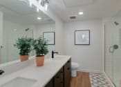 Thumbnail 19 of 30 - a bathroom with a sink and a toilet and a shower