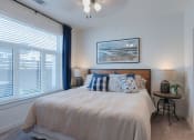Thumbnail 11 of 30 - a bedroom with a large window and a bed