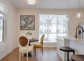Thumbnail 7 of 30 - A dining area with a table and chairs.