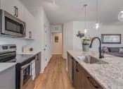 Thumbnail 9 of 30 - a kitchen with a marble counter top and a sink
