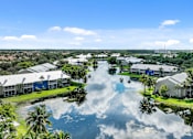 Thumbnail 1 of 42 - an aerial view of a flooded neighborhood with palm trees and houses