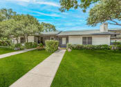 Thumbnail 20 of 20 - the front of a house with a lawn and sidewalk