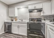 Thumbnail 3 of 20 - a kitchen with white cabinets and stainless steel appliances